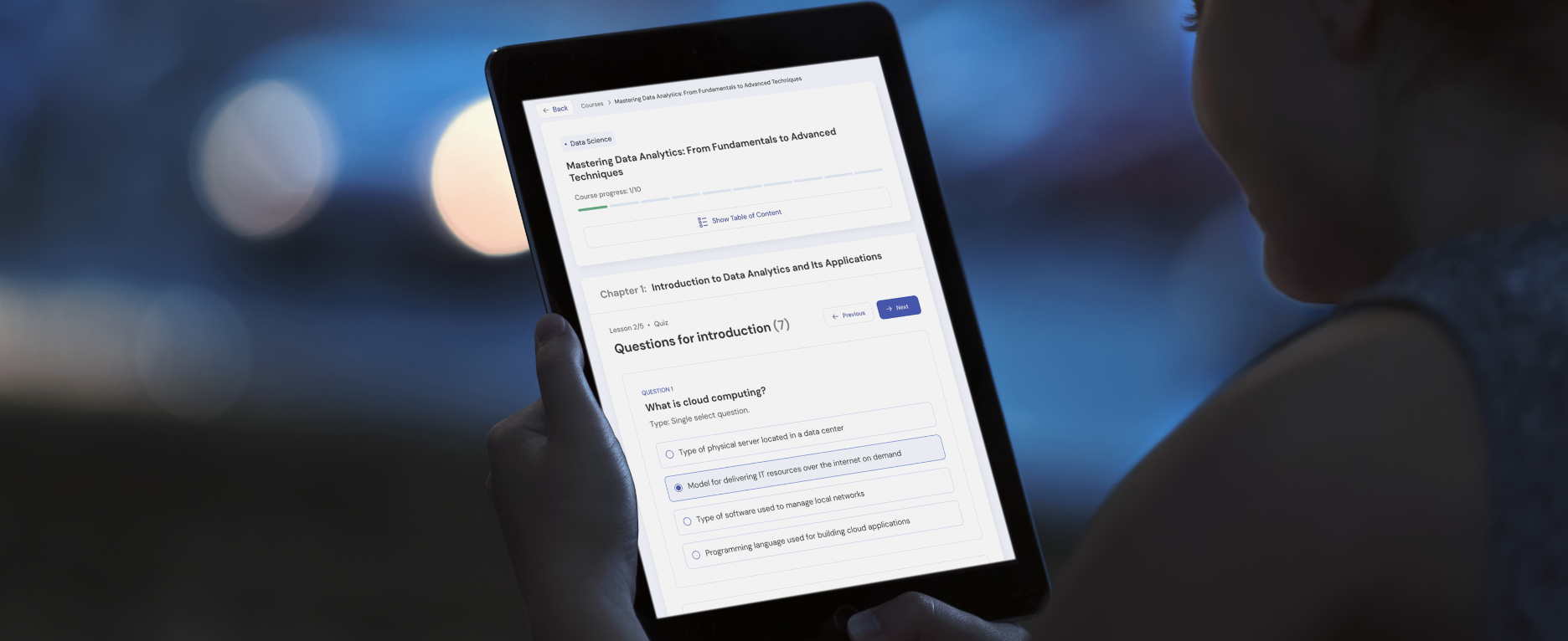 Person using a tablet with Mentingo LMS learning interface